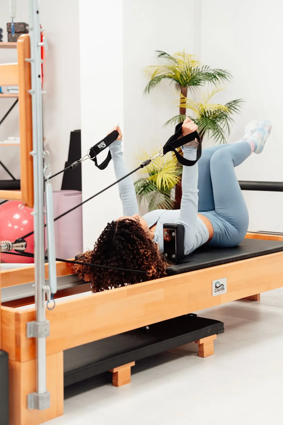 Mulher praticando exercício no aparelho de pilates
